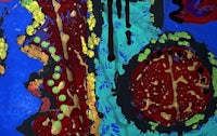 a painting with red, blue, and yellow paint on a blue background
