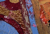 a close up of a painting with red and blue colors